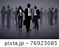 Outline of a group of business people on a black background 76923085