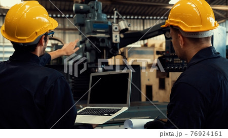 Skillful factory worker working with laptop computer to do procedure checklist . 76924161