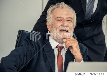 Old senior manager working in office. 76925144