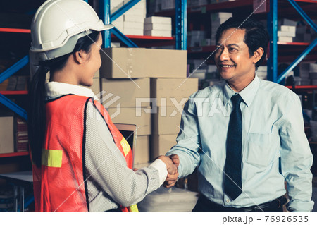 Warehouse manager and worker working in the storehouse 76926535