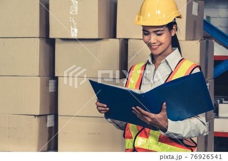 Female warehouse worker working at the storehouse 76926541