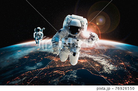 Astronaut spaceman do spacewalk while working for space station 76926550