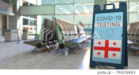 COVID-19 testing text and flag of Georgia on a sandwich board sign in the airport terminal, 3D rendering 76926683