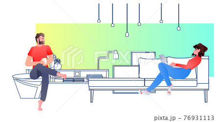 people using digital gadgets man woman couple relaxing on sofa social media online communication concept people using digital gadgets man woman couple relaxing on sofa social media online communication concept 76931113