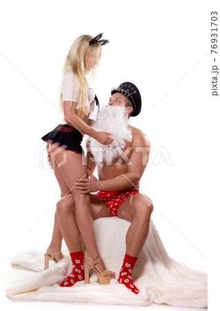 Man in Santa role play with dominance blonde woman 76931703