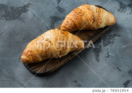 Tasty buttery croissants, on gray stone background, with copy space for text 76931954