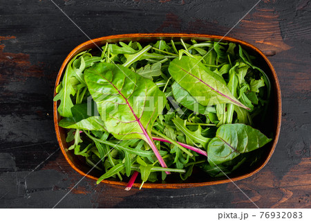 Arugula, Chard herbs mix , on old dark wooden table background, top view flat lay 76932083