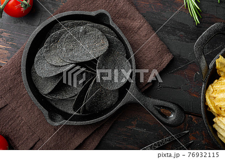 Cheese and chive potato crisp snack, on old dark wooden table , top view flat lay 76932115