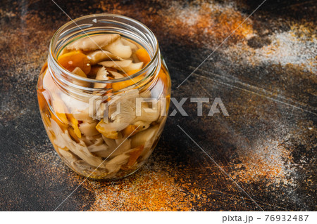 Marinated mushrooms, on old dark rustic background , with space for text copyspace 76932487