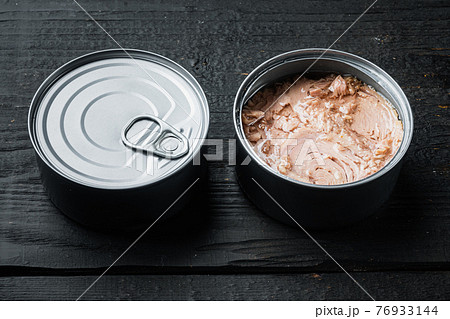 Canned Albacore Wild Tuna, in tin can, on black wooden table background Canned Albacore Wild Tuna, in tin can, on black wooden table background 76933144