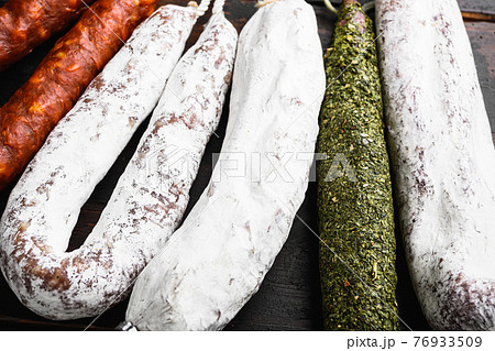 Spanish wurst hanging on wooden background 76933509