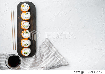 Philadelphia roll sushi with salmon, prawn, avocado, cream cheese, on white stone background, top view flat lay , with copyspace and space for text Philadelphia roll sushi with salmon, prawn, avocado, cream cheese, on white stone background, top view flat lay , with copyspace and space for text 76933547