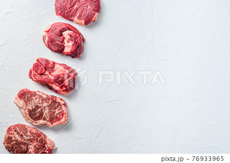 Raw set of alternative beef cuts Chuck eye roll, top blade, rump steak. Organic meat. White textured background.Top view with space for text. 76933965