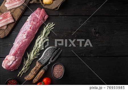 Raw Pork fillet with sage, on black wooden table background, top view flat lay , with copyspace and space for text Raw Pork fillet with sage, on black wooden table background, top view flat lay , with copyspace and space for text 76933985