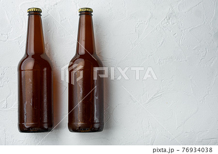 Beer bottle, on white stone surface, top view flat lay, with copy space for text 76934038