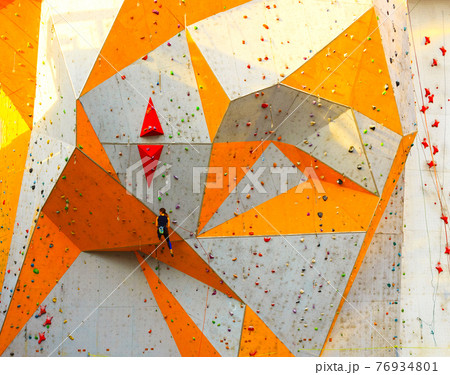 The active young woman on rock wall in sport center 76934801
