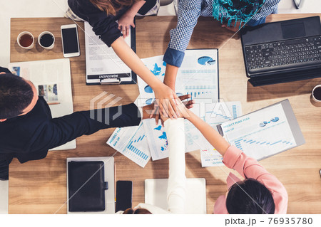 Teamwork business people join hands in meeting. Teamwork business people join hands in meeting. 76935780