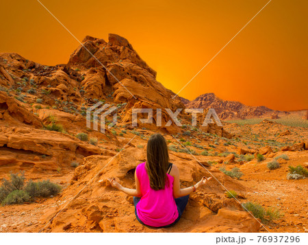 Young woman meditating outdoors 76937296