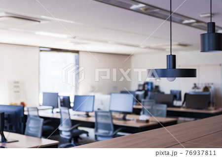 コロナ禍でテレワークにより閑散としているオフィスのイメージ 76937811