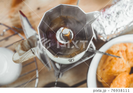 Coffee making with Moka pot and snack. Coffee making with Moka pot and snack. 76938111