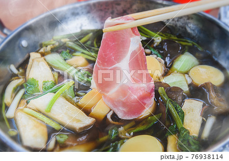 Hot soup vegetables and meats shabu style. 76938114