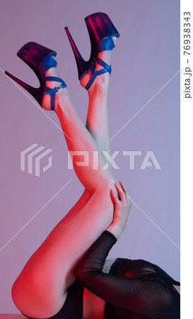 Beautiful female legs in blue high-heeled shoes for pole dance. Beautiful female legs in blue high-heeled shoes for pole dance. 76938343