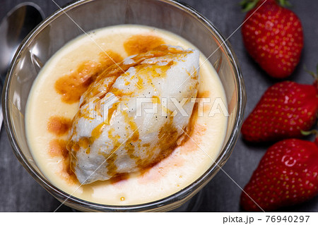 Snowy eggs and custard recipe on black background 76940297
