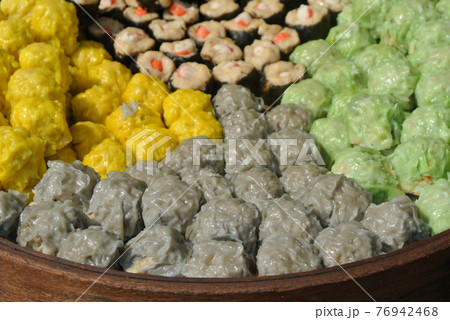 Dim Sum with miscellaneous taste in wooden steam cooker. Dim Sum is one of the famous Chinese food. It is cooked by steam at a high temperature.  76942468