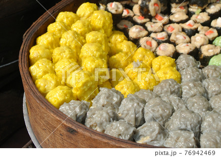 Dim Sum with miscellaneous taste in wooden steam cooker. Dim Sum is one of the famous Chinese food. It is cooked by steam at a high temperature.  76942469