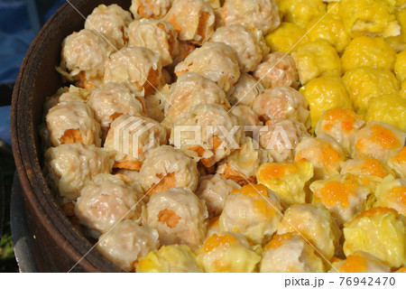 Dim Sum with miscellaneous taste in wooden steam cooker. Dim Sum is one of the famous Chinese food. It is cooked by steam at a high temperature.  76942470