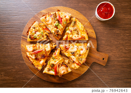 seafood pizza on wood tray 76942643