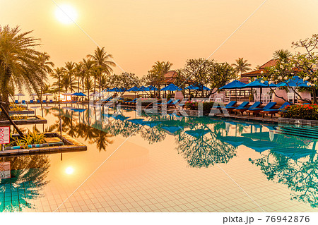palm tree with umbrella chair pool in luxury hotel resort at sunrise times palm tree with umbrella chair pool in luxury hotel resort at sunrise times 76942876