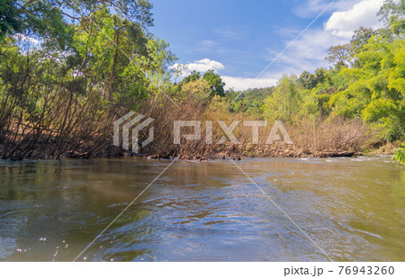 Sailing on lake or river water rafting, paddling on boat canal in park. Sightseeing in forest trees at Mae Sot ,Tak, Thailand. Nature landscape. Tourist adventure activity. Travel in holiday vacation. Sailing on lake or river water rafting, paddling on boat canal in park. Sightseeing in forest trees at Mae Sot ,Tak, Thailand. Nature landscape. Tourist adventure activity. Travel in holiday vacation. 76943260