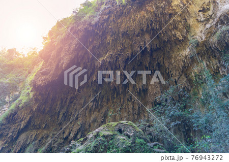 Natural stalactite and stalagmite rock stone cliff hang from cave ceiling in cave. Environmental explore. Landscape background. Erosion Natural stalactite and stalagmite rock stone cliff hang from cave ceiling in cave. Environmental explore. Landscape background. Erosion 76943272