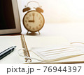 Work from home, stay at home, learning online education to avoid corona virus or COVID-19 concept : Anti virus protection mask on open notebook paper, digital tablet and clock on working desk table 76944397