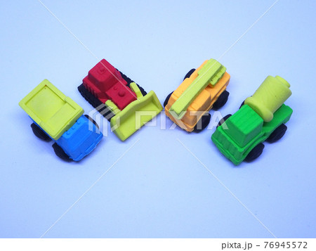 Miniature model of construction heavy machine made from colorful synthetic rubber isolated on white background.  76945572
