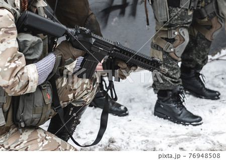 The military with rifles perform the task. 76948508