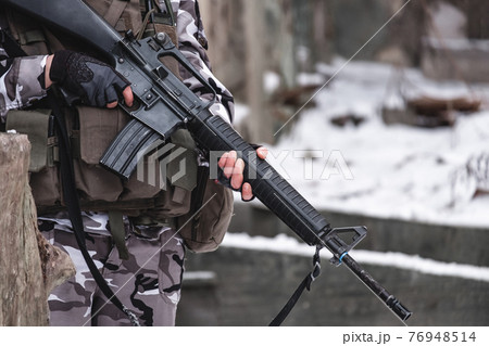 A hired soldier in camouflage near a sleep guard post. 76948514