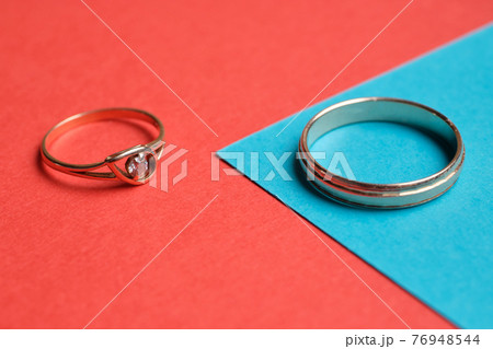 Wedding rings on a red and blue background. Wedding rings on a red and blue background. 76948544
