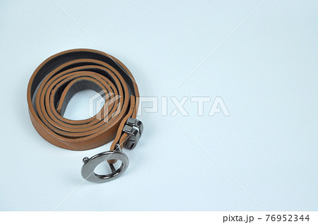 Brown lady waist belt isolated on white background.The waist belt was made from PU leather.  76952344