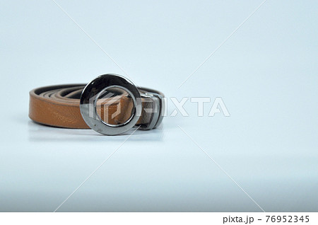 Brown lady waist belt isolated on white background.The waist belt was made from PU leather. Brown lady waist belt isolated on white background.The waist belt was made from PU leather. 76952345