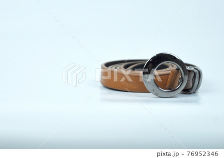 Brown lady waist belt isolated on white background.The waist belt was made from PU leather. Brown lady waist belt isolated on white background.The waist belt was made from PU leather. 76952346