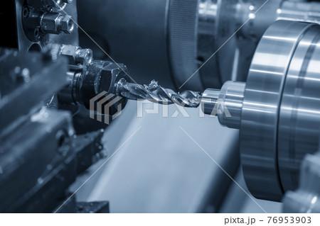 The CNC lathe machine bore cutting the metal shaft. The CNC lathe machine bore cutting the metal shaft. 76953903