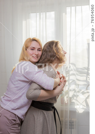 A young girl congratulates her mother on the holiday. A young girl congratulates her mother on the holiday. 76954060