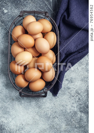 Eggs in a metal basket with tablecloth Eggs in a metal basket with tablecloth 76954562
