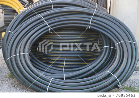 Coiled hoses for sale on a street in a southern city, April 2021 76955463