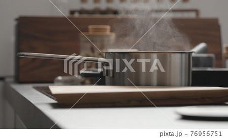 steam rising from saucepan on kitchen 76956751