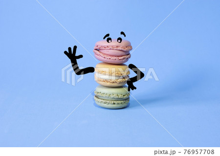 cartoon drawn on coloured macarons on a blue background 76957708
