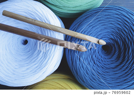 Colorful skeins of yarn and crochet hooks . Hobbies, crafts. Colorful skeins of yarn and crochet hooks . Hobbies, crafts. 76959602