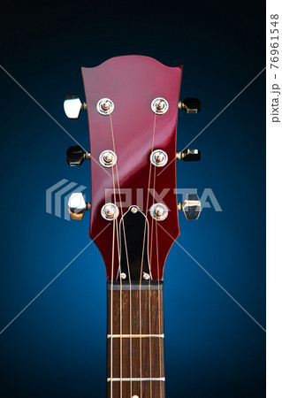 electric guitar head, blue background 76961548